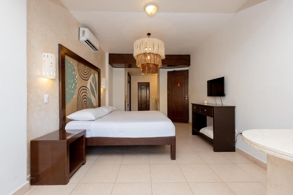 Cama ou camas em um quarto em Hotel Kinich