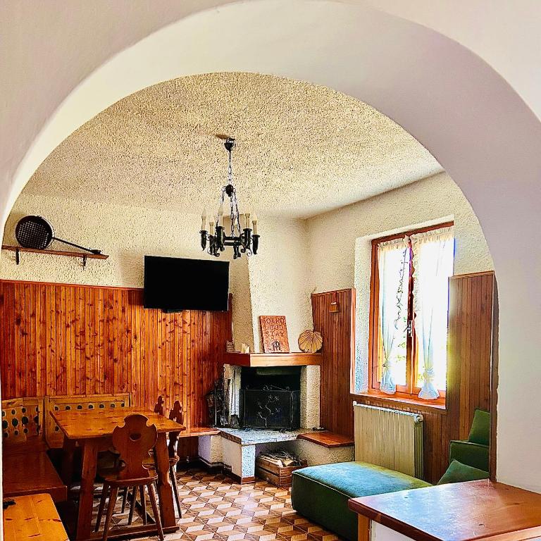 a living room with a table and a fireplace at Good Stay Borno in Borno