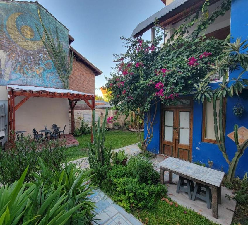 a blue house with a bench in front of it at Nido, Los Colibríes VI in Tigre