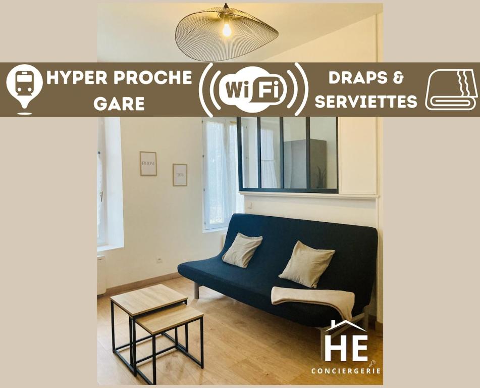 a living room with a blue couch and a table at Room 203 Hyper Proche Gare 250m in Montargis