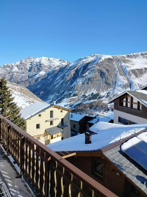 a view from the balcony of a resort with snow covered mountains at Lika in Livigno