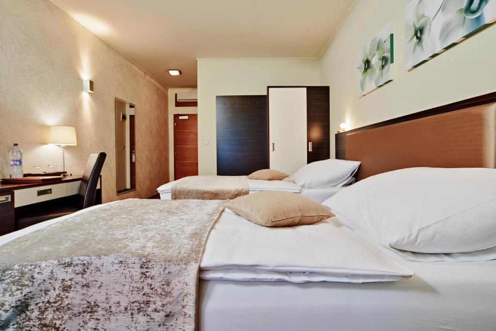 Postel nebo postele na pokoji v ubytování Privilege Apartments