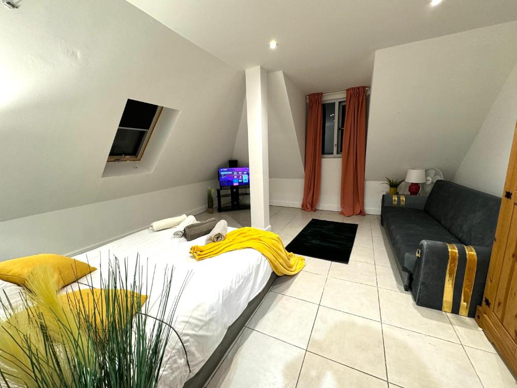 a living room with a bed and a couch at A modern luxury penthouse close to London Tower-HIl-Canary Wharf-Central London in London