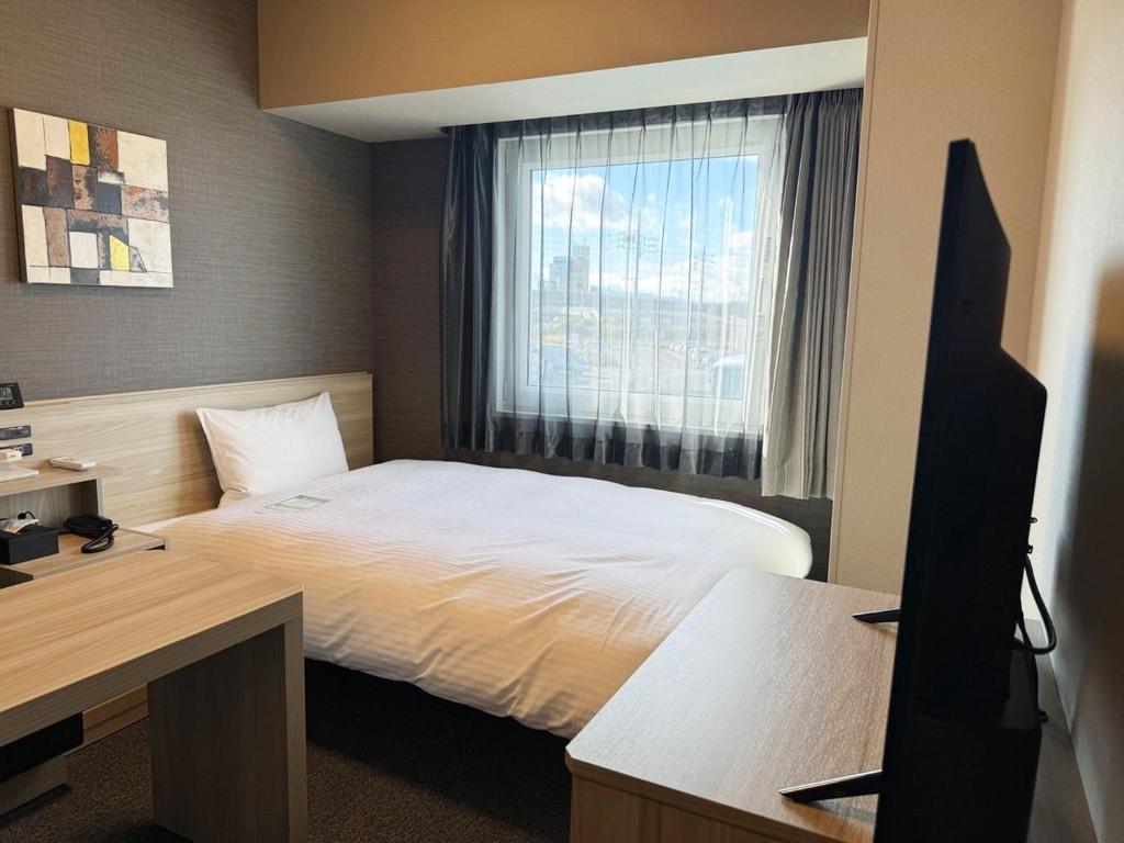 Postel nebo postele na pokoji v ubytování Hotel Route Inn Ginan -Kokudo 21 Gou-