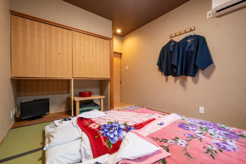 Postel nebo postele na pokoji v ubytování Ryokan Yamazaki