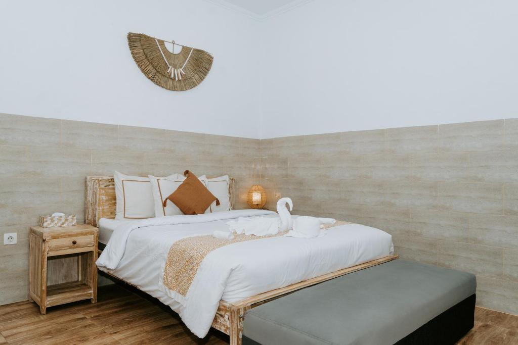 Postel nebo postele na pokoji v ubytování Agung Wiwin Homestay & Restaurant