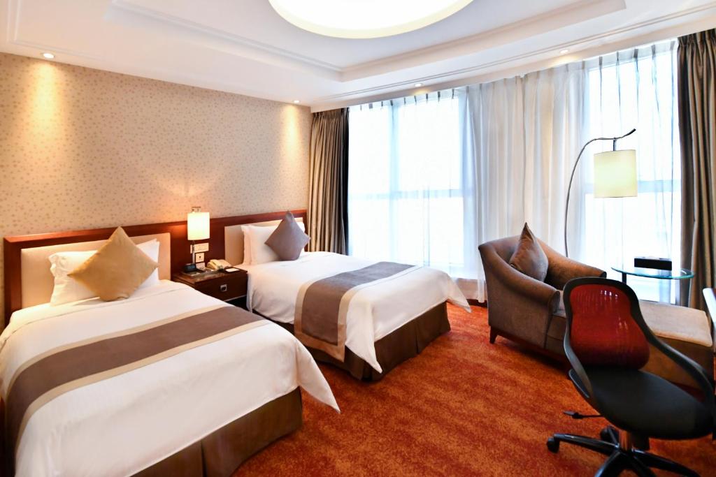 Postel nebo postele na pokoji v ubytování Central Hotel Shanghai - Nanjing Road