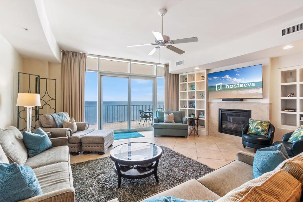 a living room with a couch and a tv at Turquoise Place 2205 C in Orange Beach