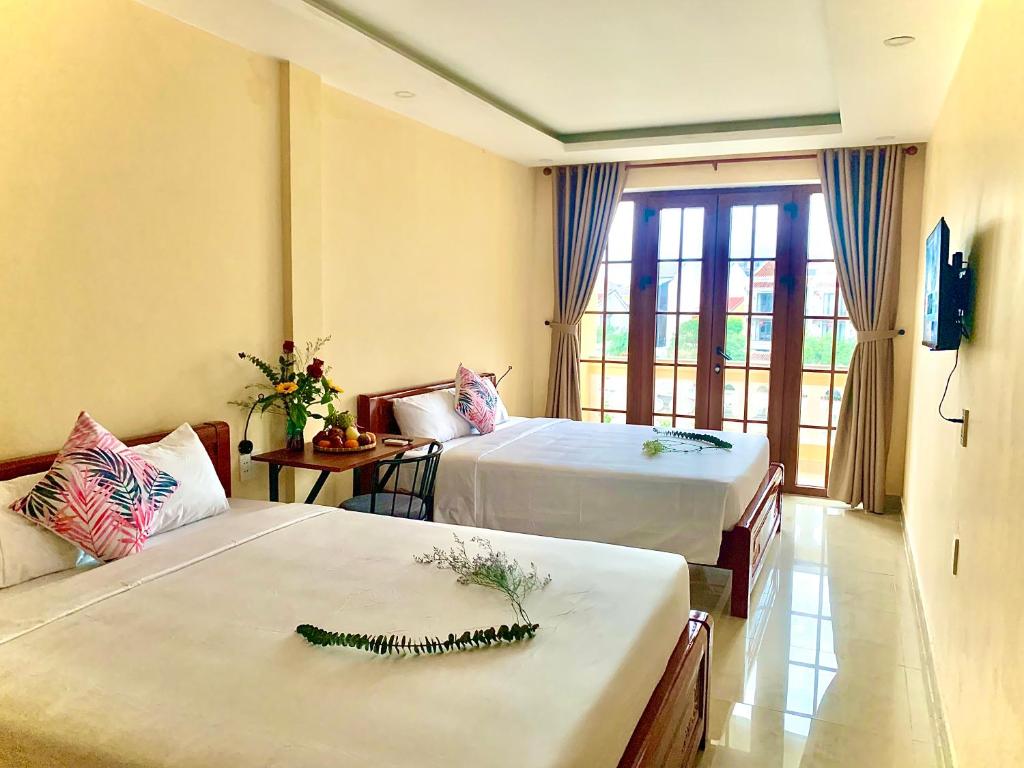 Giường trong phòng chung tại Aman Riverside Hotel