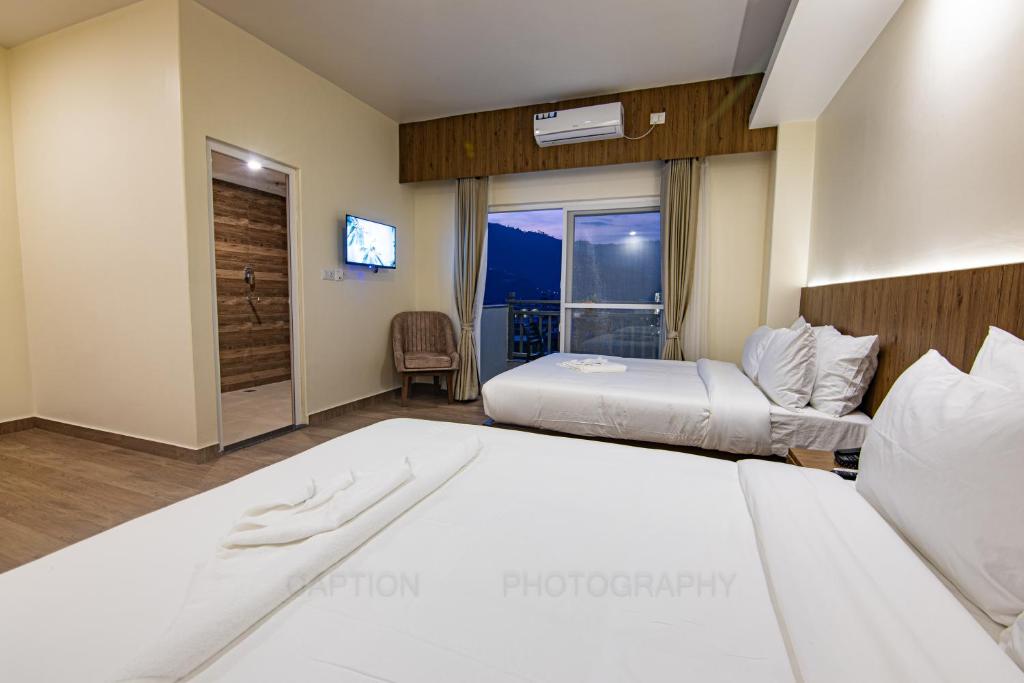 Postel nebo postele na pokoji v ubytování Hotel Dashain