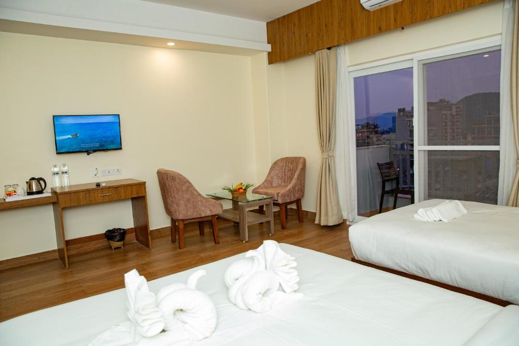Postel nebo postele na pokoji v ubytování Hotel Dashain