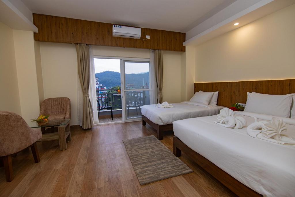 Postel nebo postele na pokoji v ubytování Hotel Dashain