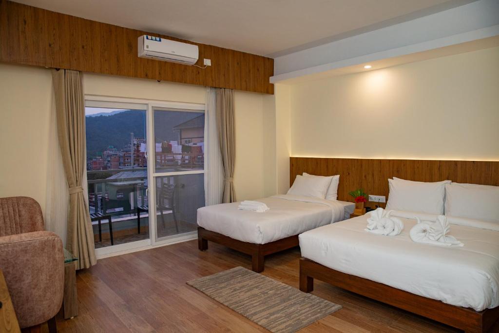 Postel nebo postele na pokoji v ubytování Hotel Dashain