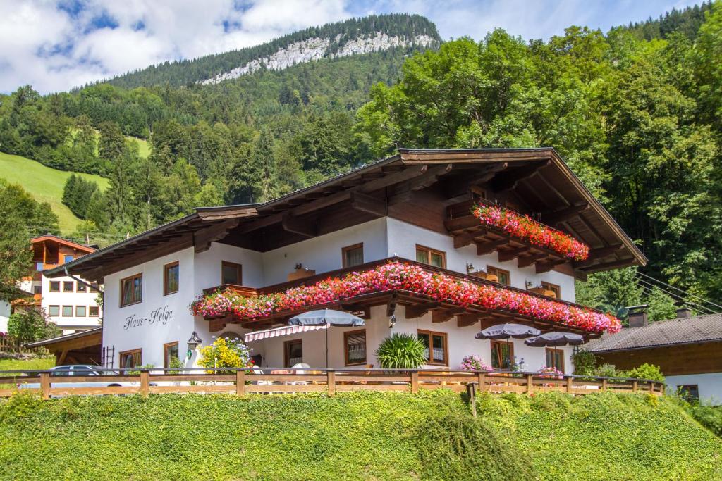 a building on a hill with flowers on it at Haus Helga in Unken