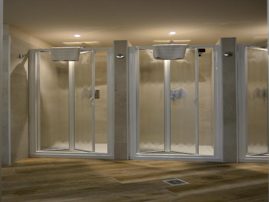 a shower with glass doors in a room at Hotel Impero in Cremona