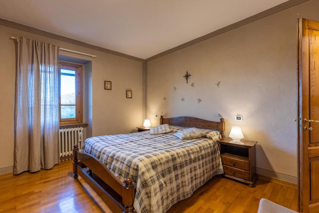 Postel nebo postele na pokoji v ubytování Il Gugnolo - Casale in Val d'Orcia