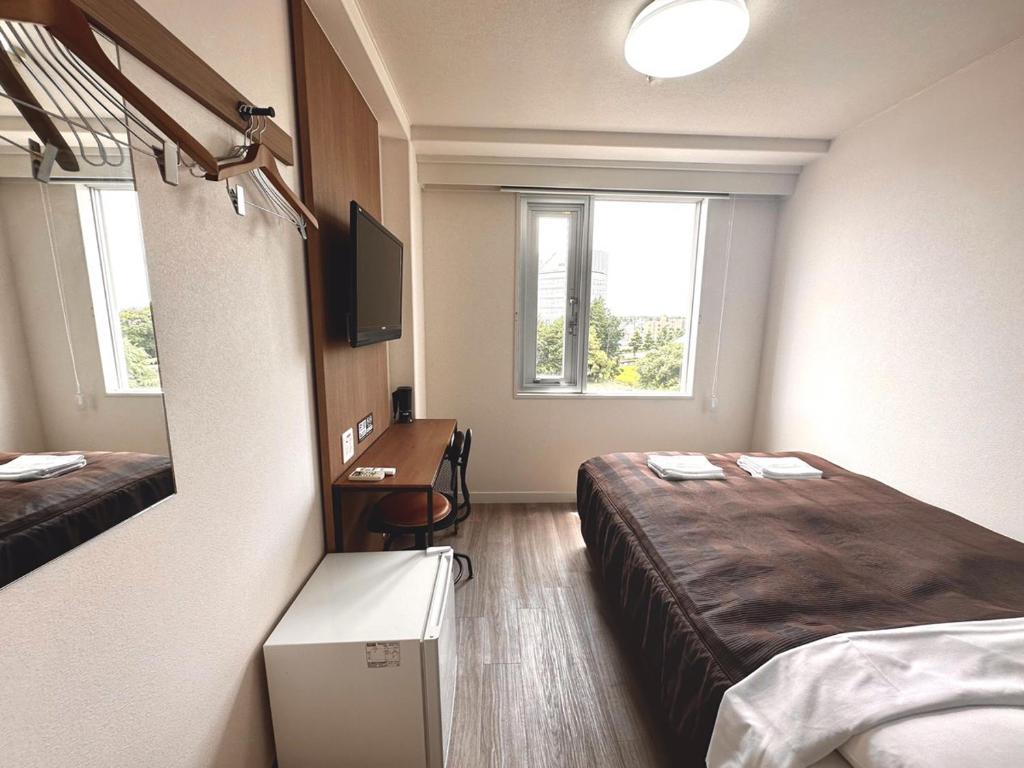 Postel nebo postele na pokoji v ubytování Tabist Tsukuba Sky Hotel