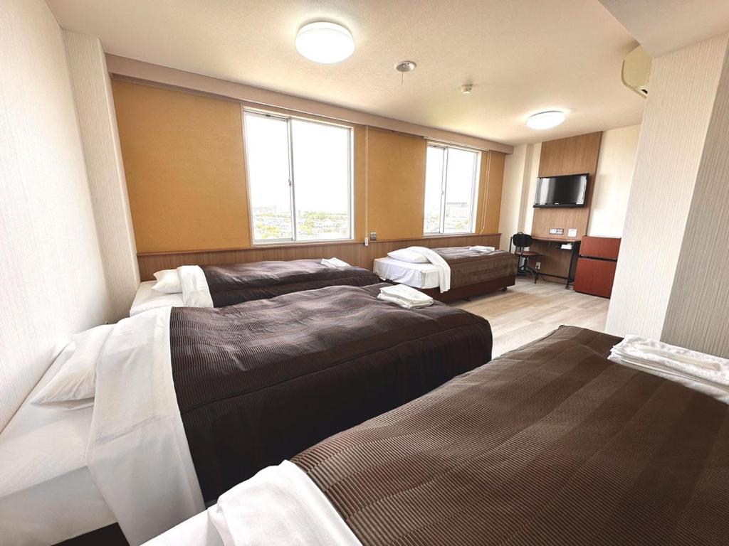 Postel nebo postele na pokoji v ubytování Tabist Tsukuba Sky Hotel
