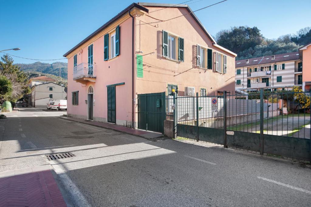a building with a fence on the side of a street at Affittacamere Monica in Levanto