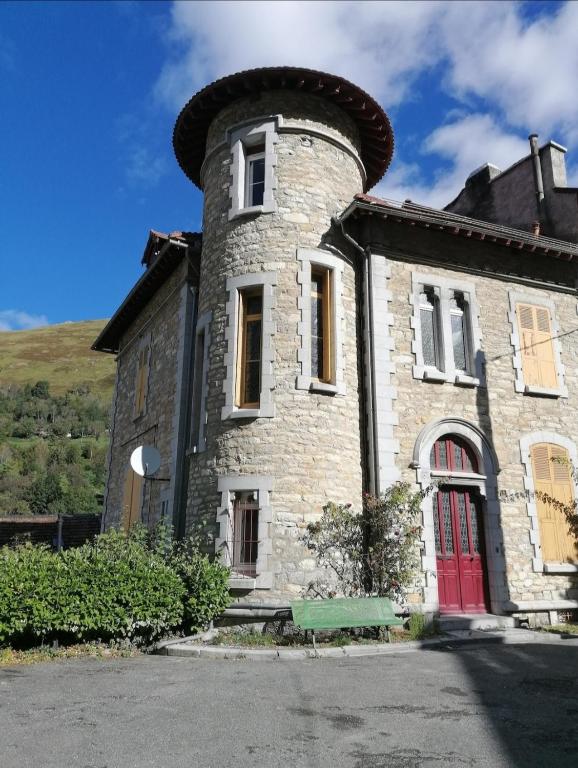 an old stone building with a chimney on it at Appartement Eaux-Bonnes in Eaux-Bonnes
