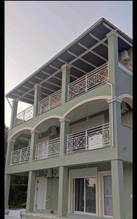 a building with balconies on the side of it at Loukas House 1Σταυρος-Κερκυρα Μακράτα in Stavrós