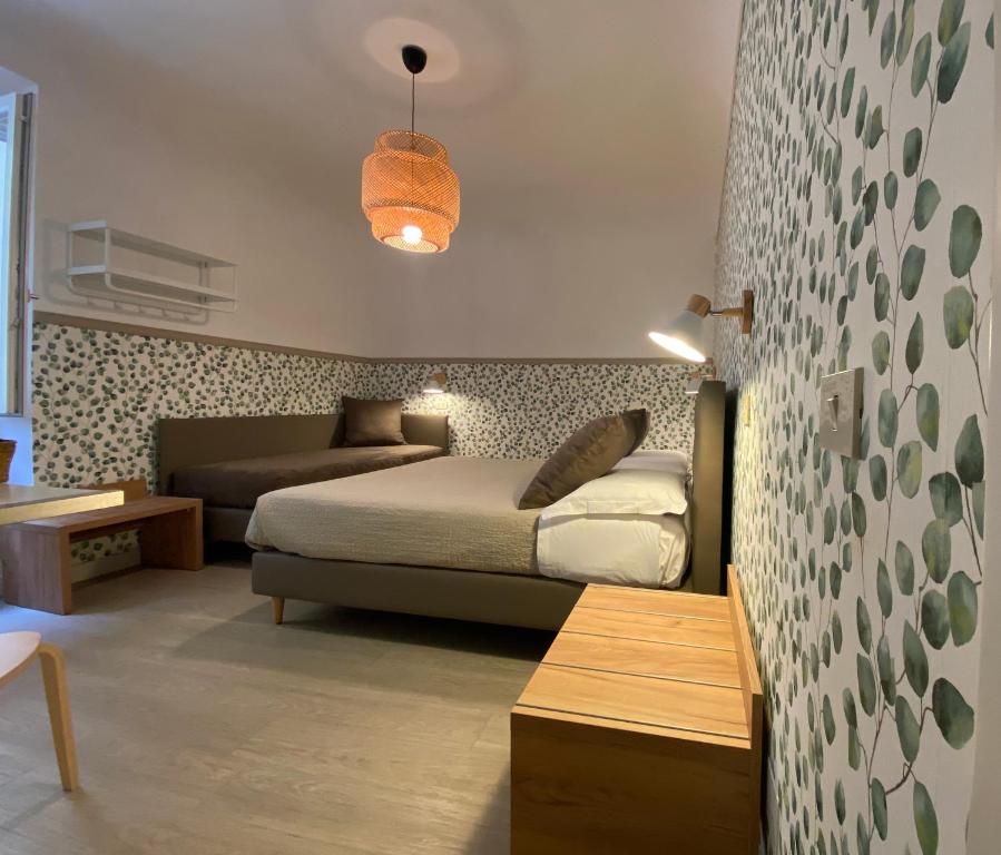 Postel nebo postele na pokoji v ubytování Hotel Nella