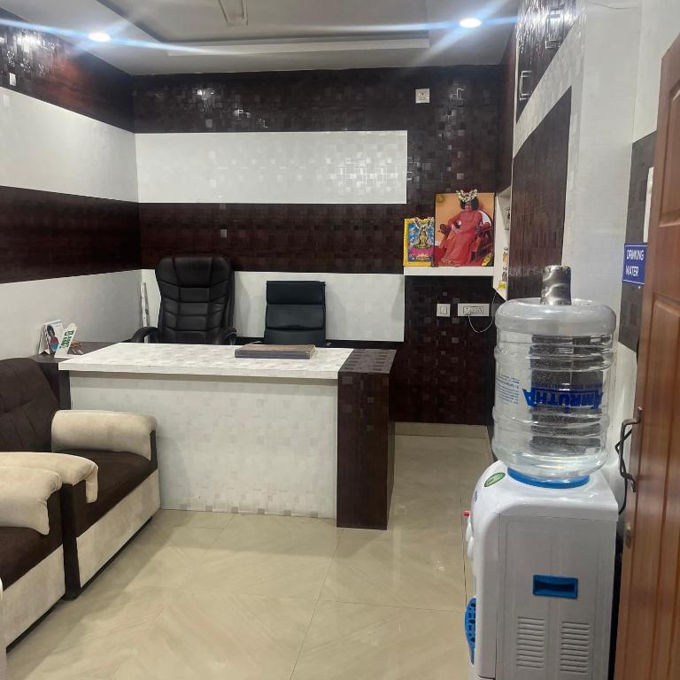 a room with a bottle of water on the floor at Svr guest house in Puttaparthi