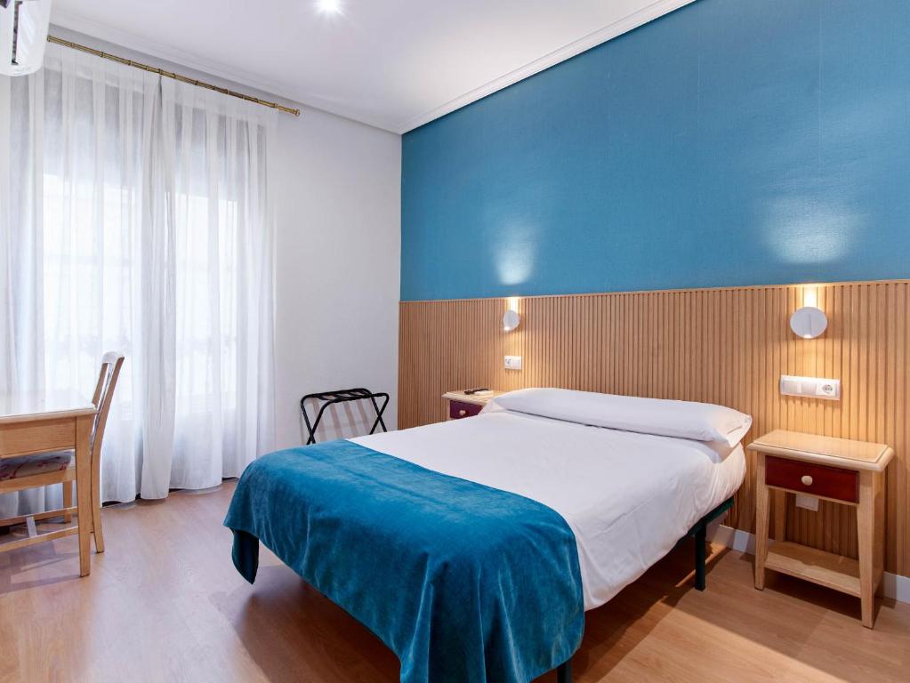 Postel nebo postele na pokoji v ubytování Hostal Bianco