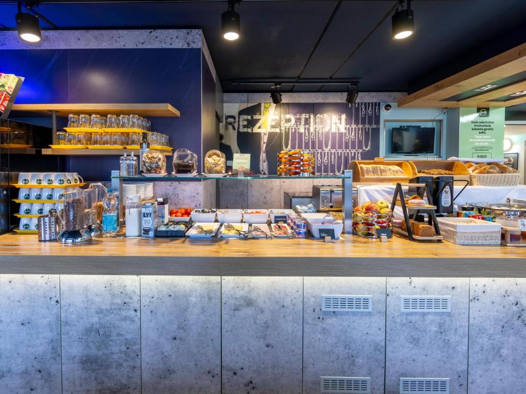 a fast food restaurant with a counter at B&B HOTEL Dortmund-Airport in Holzwickede