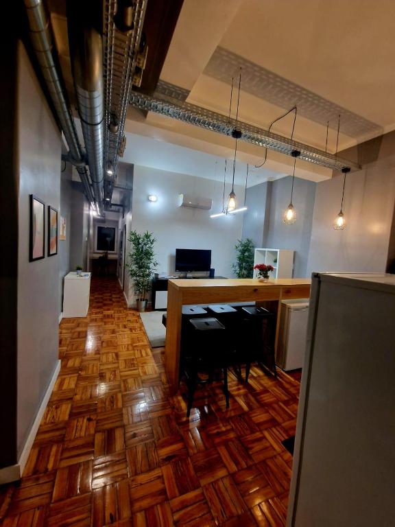 an office space with a wooden floor and a bar at Home Carriche in Lisbon