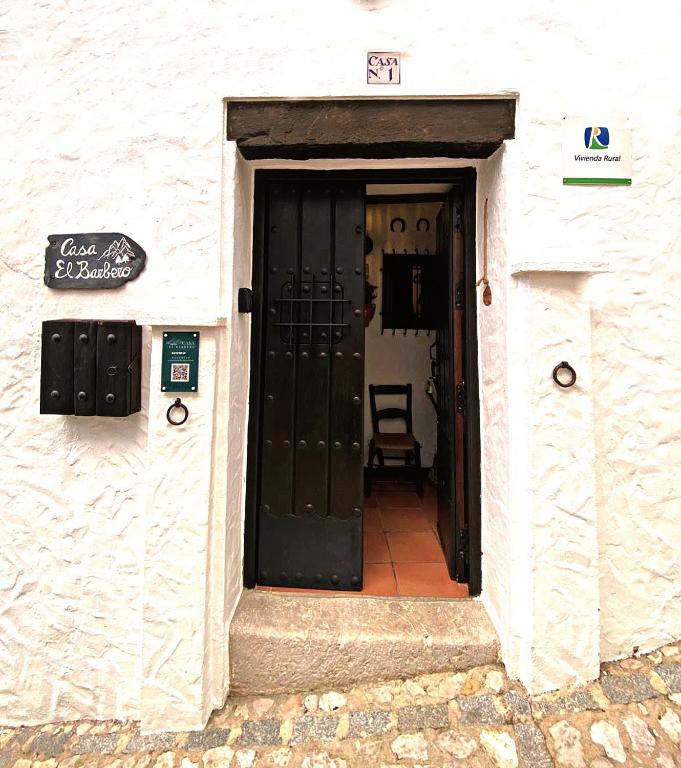 a doorway to a white building with a black door at Casa El Barbero 1810 in Benaocaz