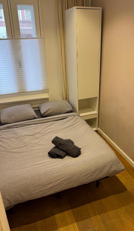 a bed with two towels on it in a bedroom at Luxury Suite - Amsterdam Lounge in Amsterdam