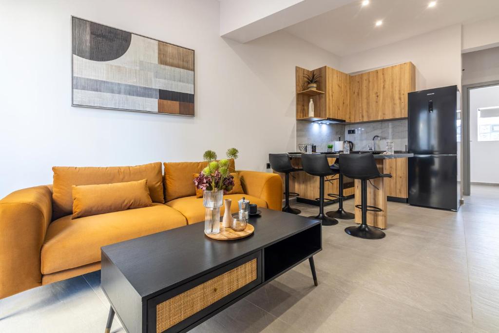 a living room with a yellow couch and a table at Gianna's Apartments in Bendevís