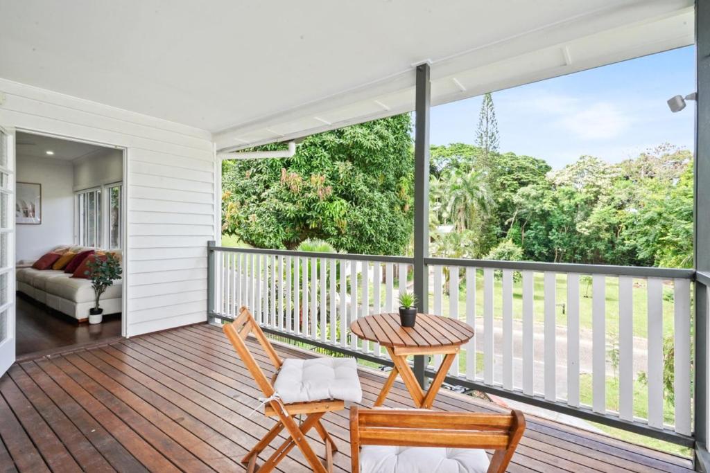 a porch with two chairs and a table on it at Rainforest Retreat - Top Haven in Stratford