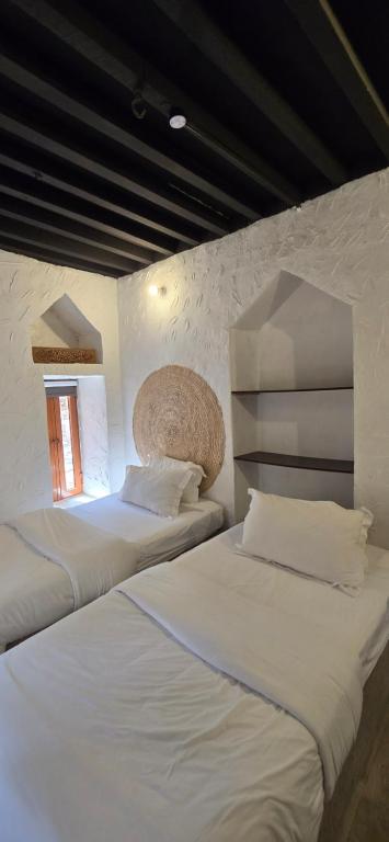 Postel nebo postele na pokoji v ubytování Riad Nizwa