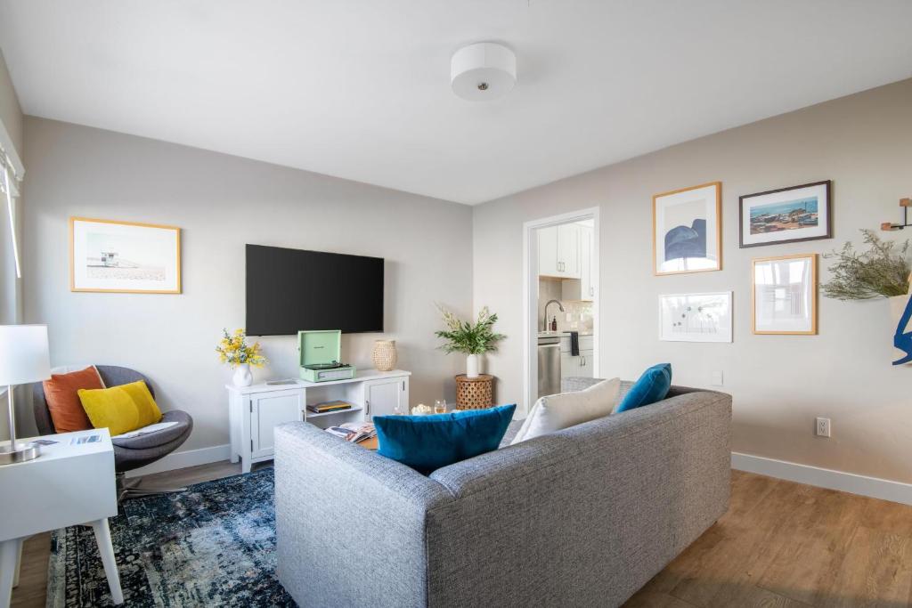 a living room with a couch and a tv at Seashore Suites by AvantStay in San Diego