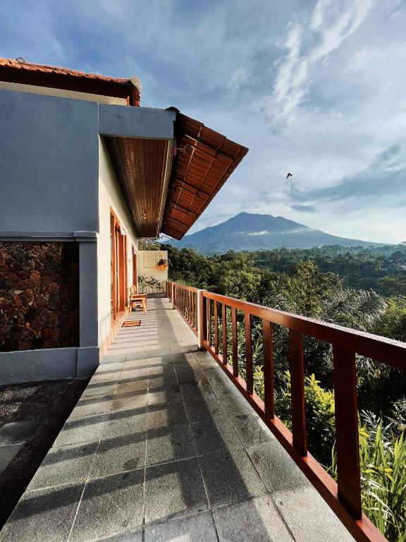 a balcony of a house with a view of the mountains at Besakih villa in Besakih