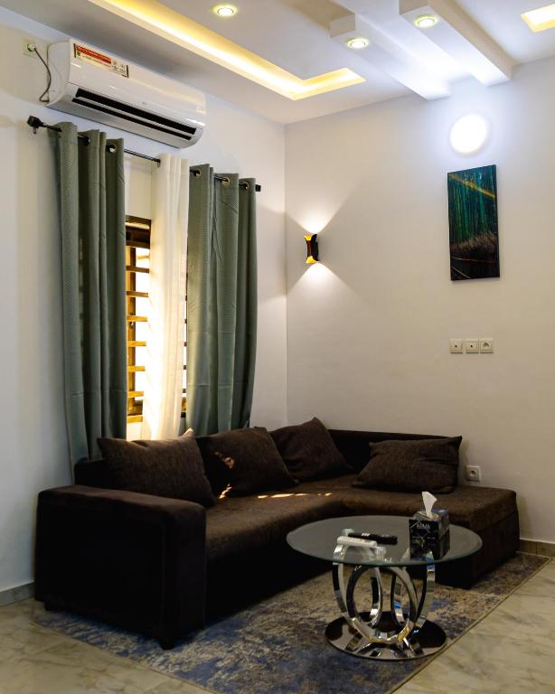 a living room with a couch and a table at Stylish 2BR Modern Apt in Cité Baguida in Lomé
