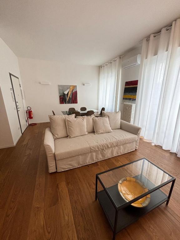 a living room with a couch and a glass table at settala 10 apartments in Milan
