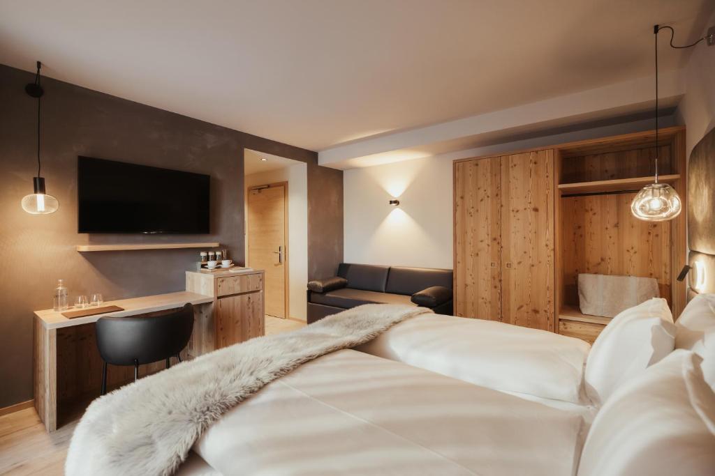 Postel nebo postele na pokoji v ubytování Hotel Tofana Cortina
