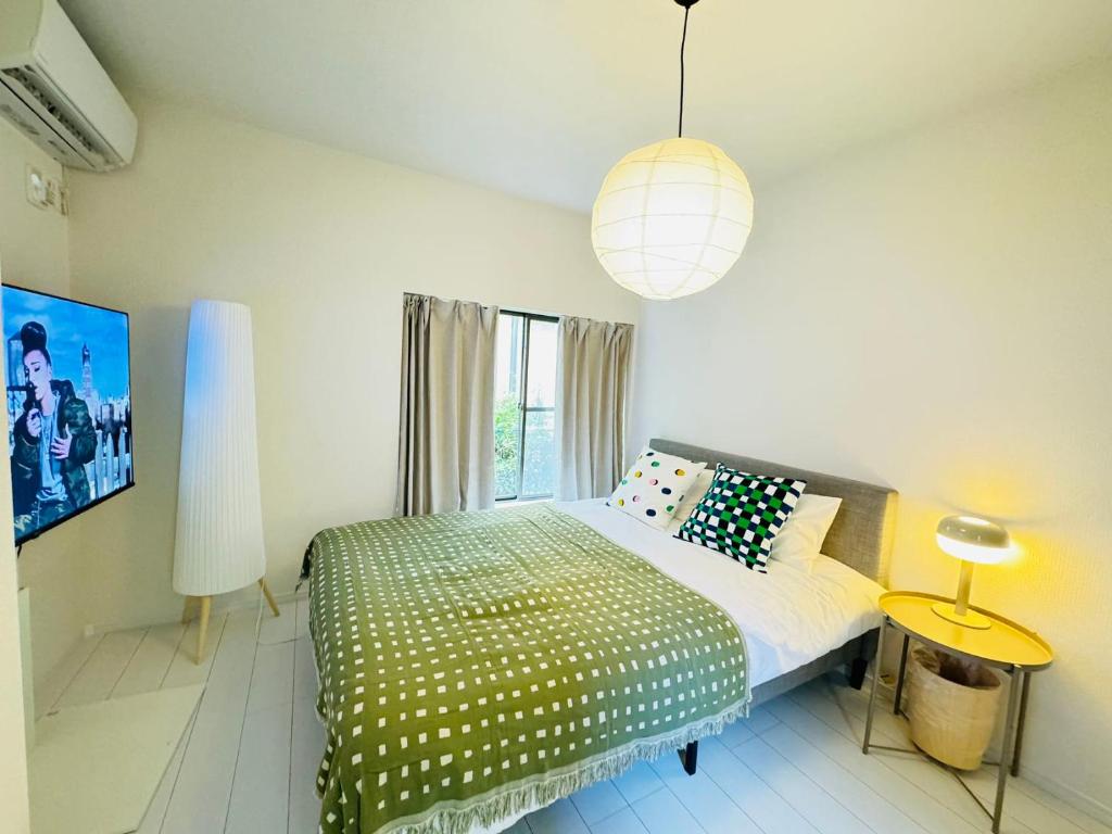 a bedroom with a bed and a large window at Ikebukuro House-TS0378 in Tokyo