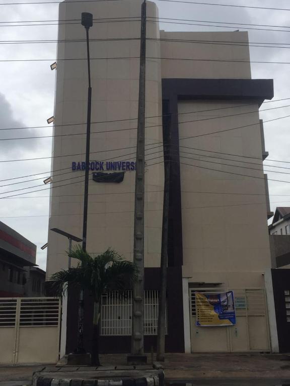 a building with a sign on the side of it at Babcock University House in Lagos
