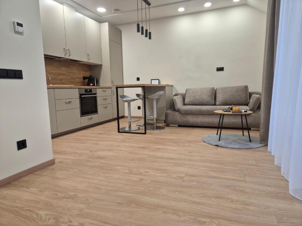 a living room with a couch and a table at New Kreves apartment & Free parking & Self check-in in Kaunas