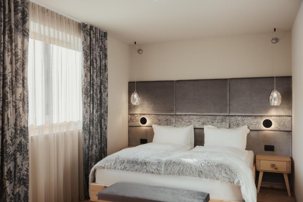 Postel nebo postele na pokoji v ubytování Hotel Tofana Cortina