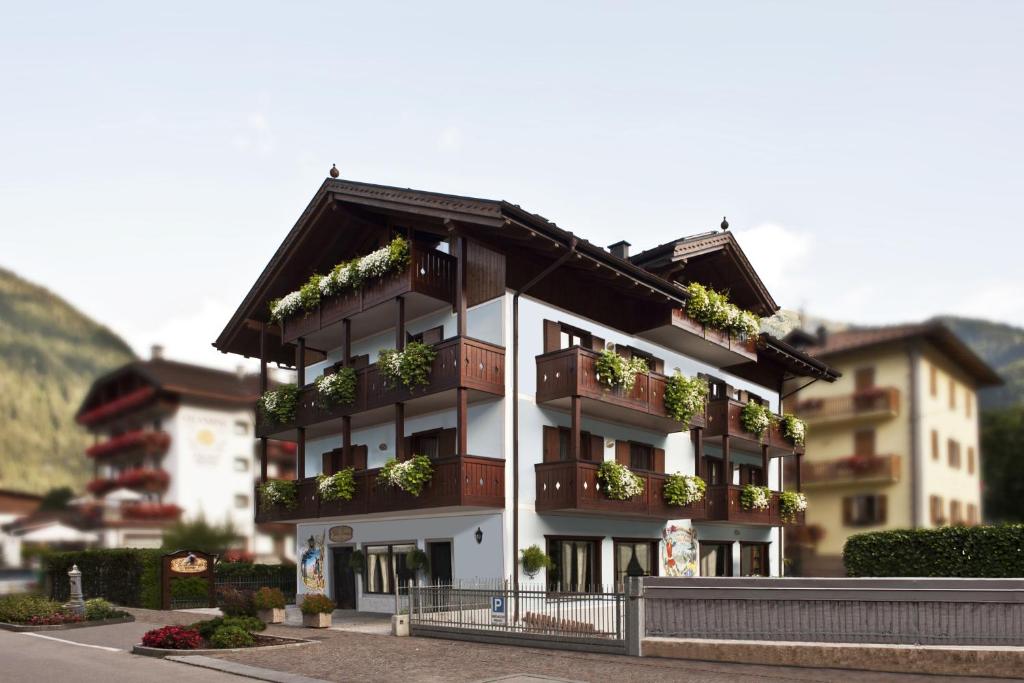 a building with plants on the balconies of it at Villa Lucin in Pinzolo