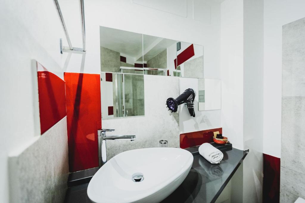 a bathroom with a white toilet and a sink at Le Cave di Fontane Bianche in Cassibile