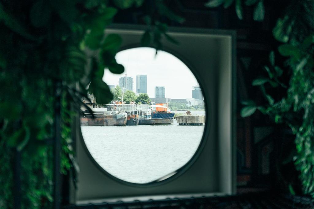 a view of a harbor through a window at Botel in Amsterdam
