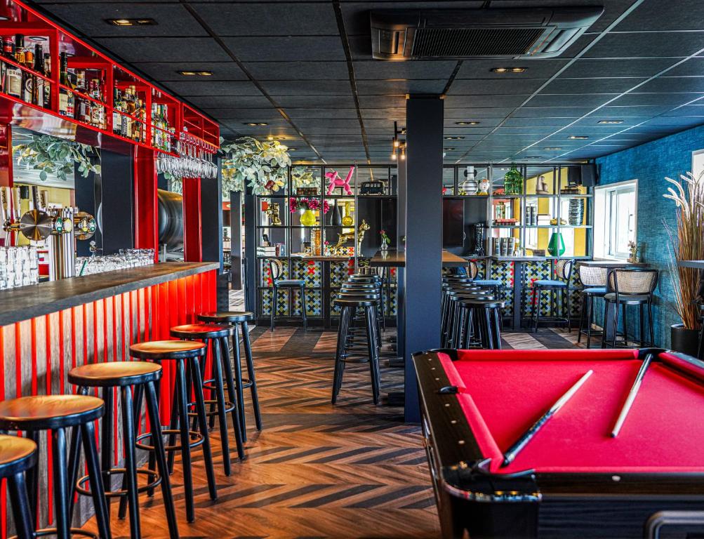 a pool table in a bar with stools at Botel in Amsterdam