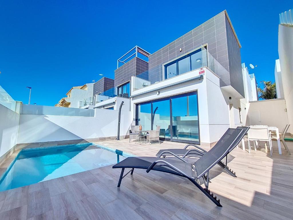 a villa with a swimming pool and a house at San Pedro del Pinatar Villa - 5010 in San Pedro del Pinatar