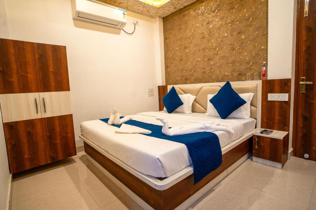 una camera da letto con un letto con lenzuola blu e bianche di The Pleasure Stay a Varanasi